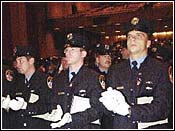 New York City firefighters stand at the end of graduation ceremony in Brooklyn. (AP)