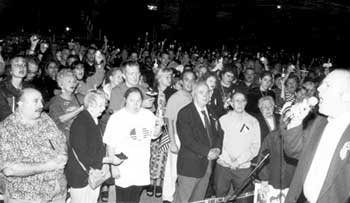 Family and friends of fallen Firefighter Kevin Smith (top photo) were among the more than 2,000 participants in Sunday night’s vigil in front of Squad 288–Hazardous Material Company One in Maspeth. The saddened but proud crowd held candles, offered prayers and sang patriotic songs. (photos: George Flo)